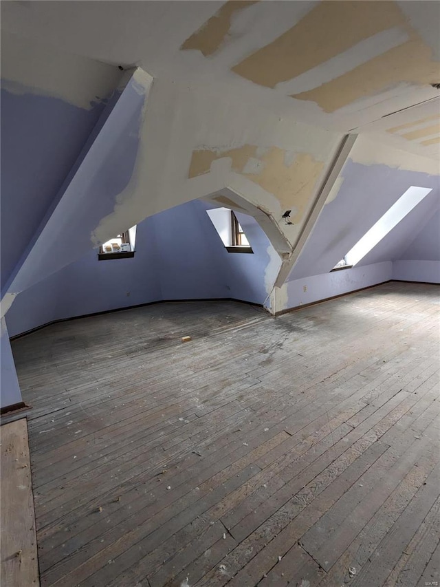 bonus room with hardwood / wood-style floors and lofted ceiling