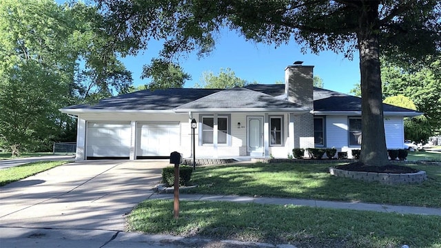 ranch-style house featuring a garage and a front lawn