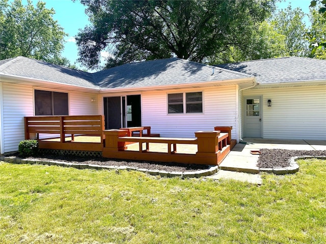 back of property featuring a deck and a yard