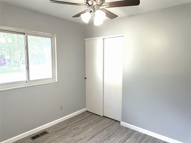 unfurnished bedroom featuring a closet, ceiling fan, and light hardwood / wood-style floors