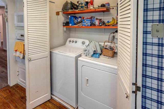 clothes washing area featuring dark hardwood / wood-style floors and independent washer and dryer