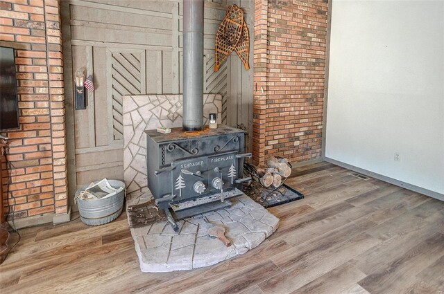 details featuring wood-type flooring and a wood stove