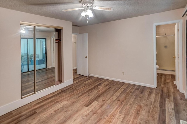 spare room with a textured ceiling, ceiling fan, and hardwood / wood-style floors