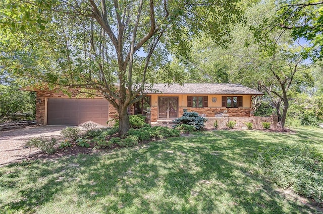 single story home featuring a garage and a front yard