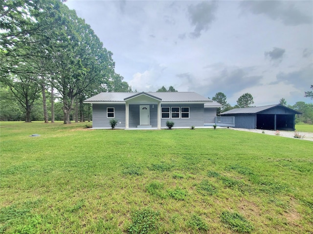 back of property with an outdoor structure and a lawn