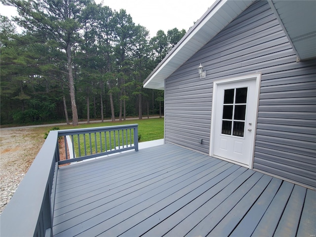 wooden terrace featuring a yard