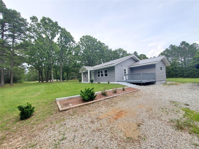 ranch-style house with a wooden deck and a front lawn