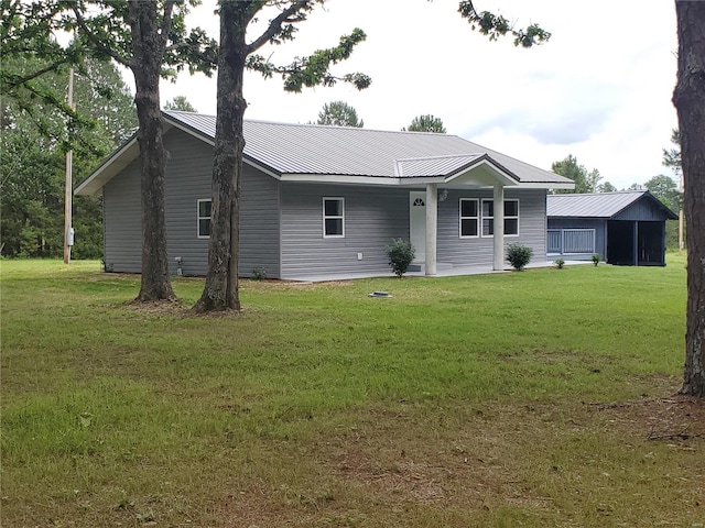 back of property featuring a yard