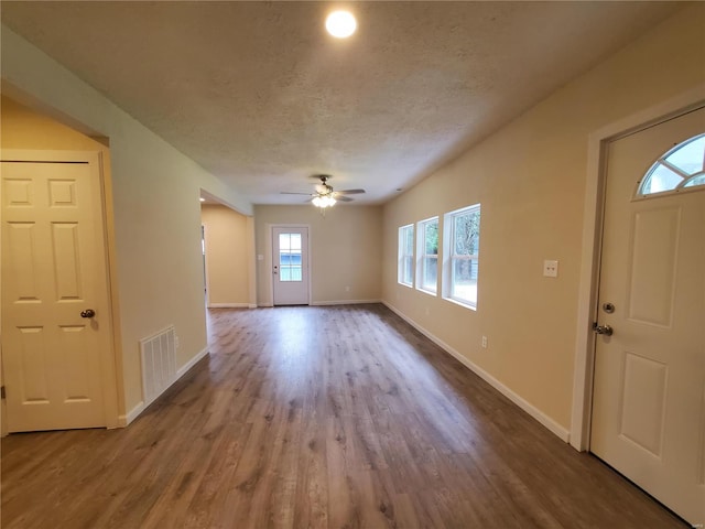 entrance foyer featuring ceiling fan, a textured ceiling, and hardwood / wood-style flooring