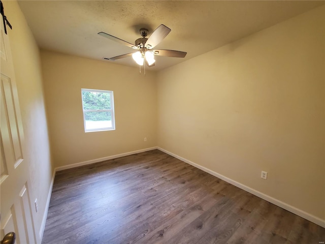 unfurnished room with ceiling fan and hardwood / wood-style flooring