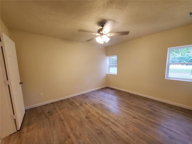 spare room with ceiling fan and hardwood / wood-style flooring