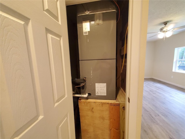 room details with hardwood / wood-style flooring, ceiling fan, and a textured ceiling