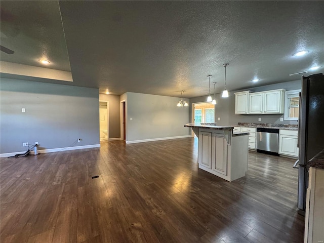 kitchen featuring a breakfast bar, decorative light fixtures, white cabinetry, a center island, and stainless steel appliances