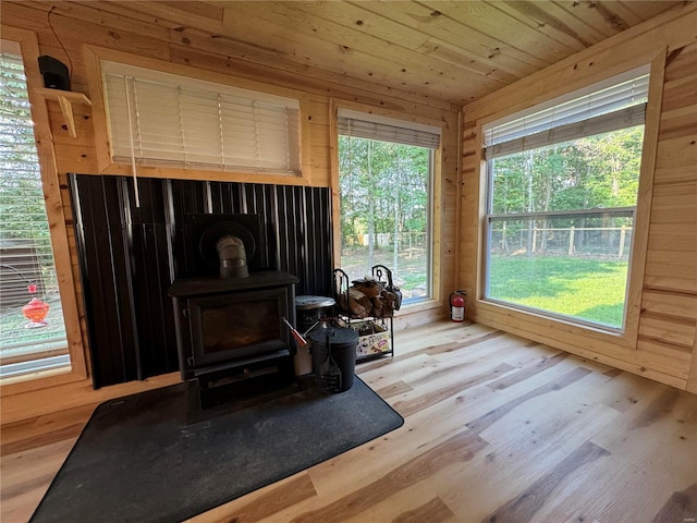 interior space featuring wooden ceiling and a wood stove