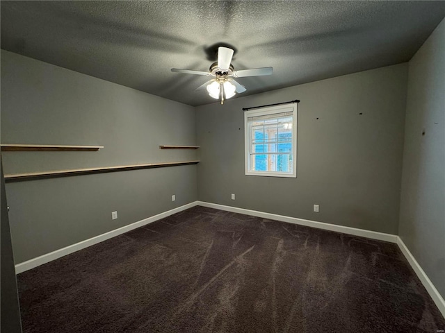 carpeted spare room featuring a textured ceiling and ceiling fan