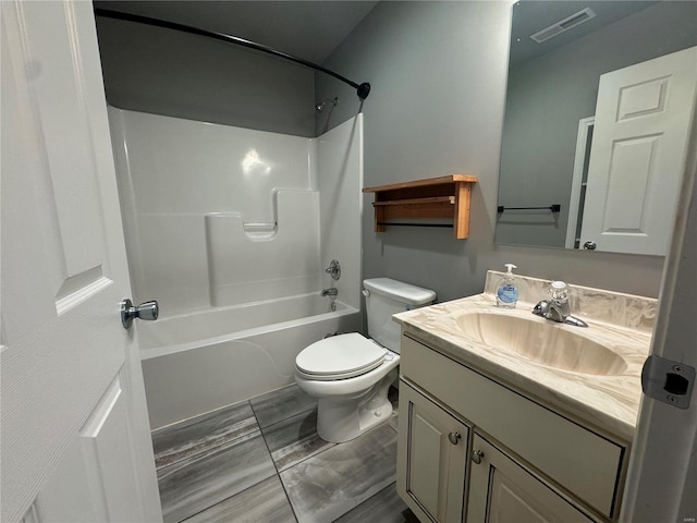 full bathroom featuring vanity, bathing tub / shower combination, and toilet