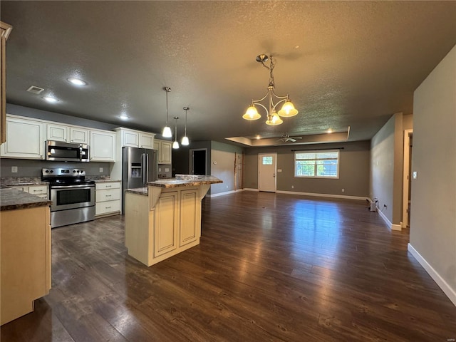 kitchen featuring pendant lighting, a breakfast bar area, stainless steel appliances, a kitchen island, and dark hardwood / wood-style flooring