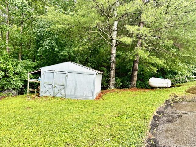 view of outdoor structure with a lawn