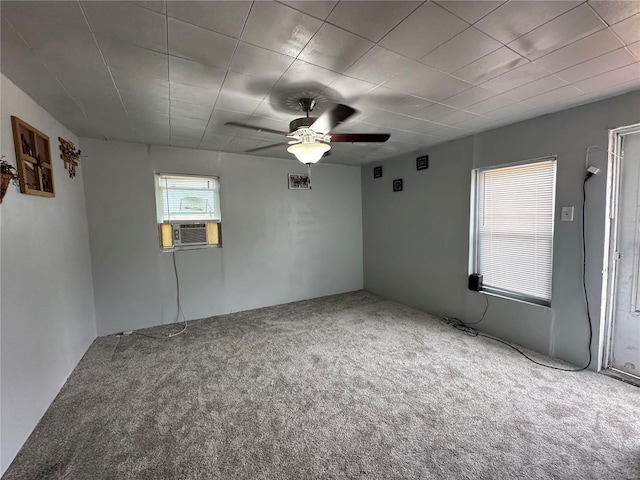 carpeted spare room featuring cooling unit and ceiling fan