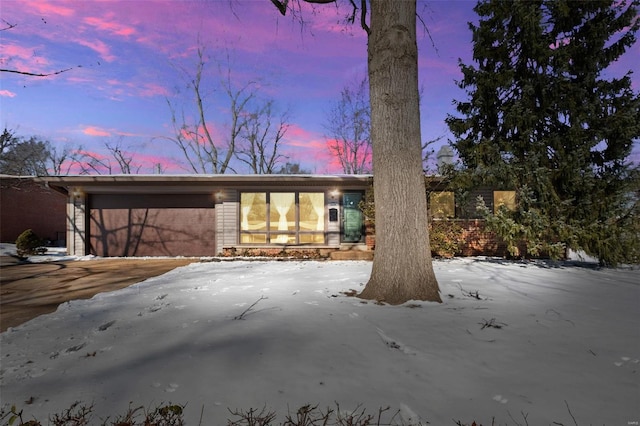 mid-century home featuring an attached garage