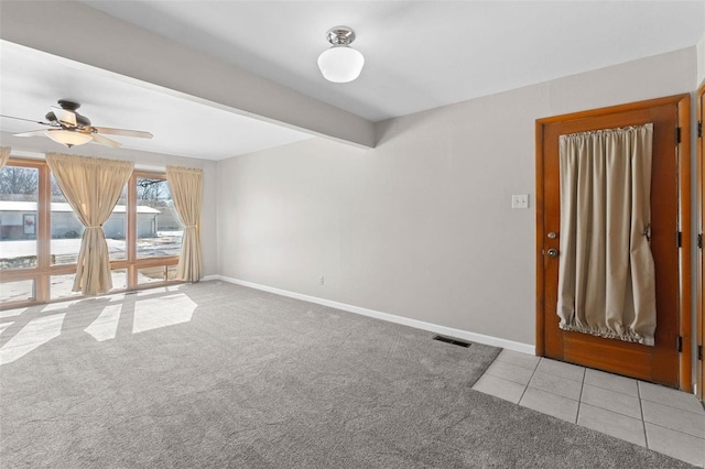 spare room with light carpet, visible vents, and baseboards