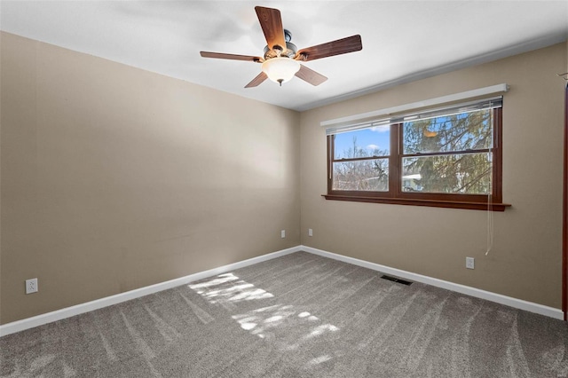 carpeted empty room featuring visible vents, baseboards, and ceiling fan