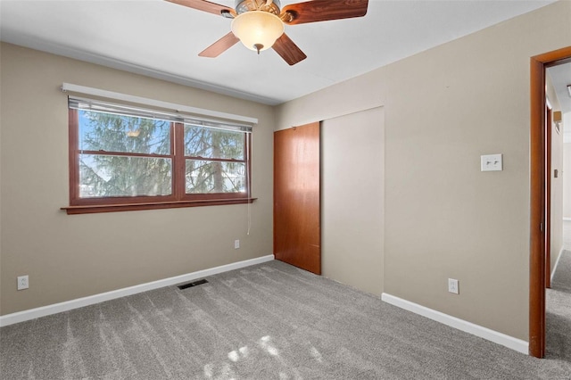 unfurnished bedroom featuring a closet, carpet flooring, visible vents, and baseboards