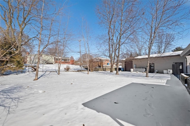 yard covered in snow with a garage