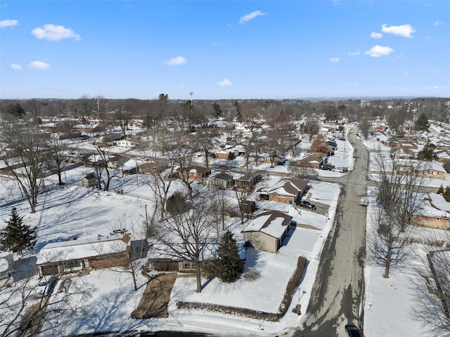 snowy aerial view with a residential view