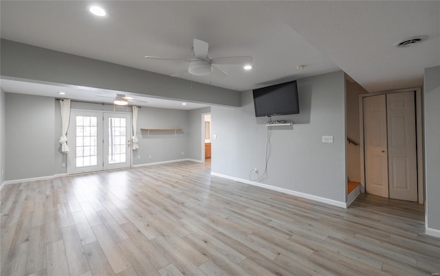 unfurnished living room with french doors, ceiling fan, and light hardwood / wood-style floors