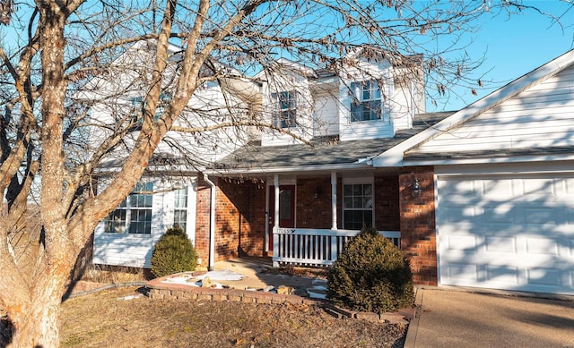 view of front of house featuring covered porch and a garage