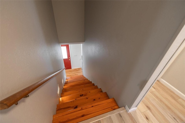 stairs with hardwood / wood-style floors