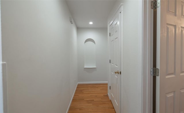 hallway with light hardwood / wood-style flooring