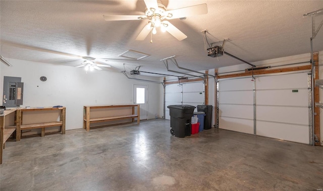 garage featuring electric panel, ceiling fan, and a garage door opener