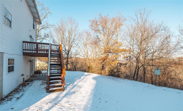 yard layered in snow with a wooden deck