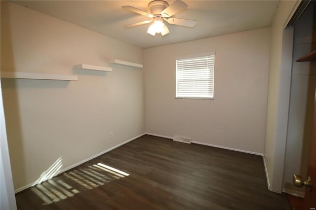 unfurnished bedroom with dark hardwood / wood-style floors and ceiling fan