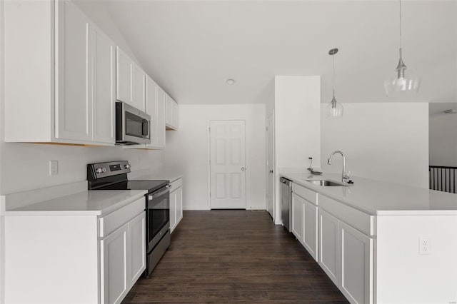 kitchen featuring dark hardwood / wood-style floors, decorative light fixtures, stainless steel appliances, white cabinetry, and sink