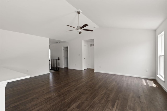 unfurnished living room featuring ceiling fan, vaulted ceiling, and dark hardwood / wood-style floors