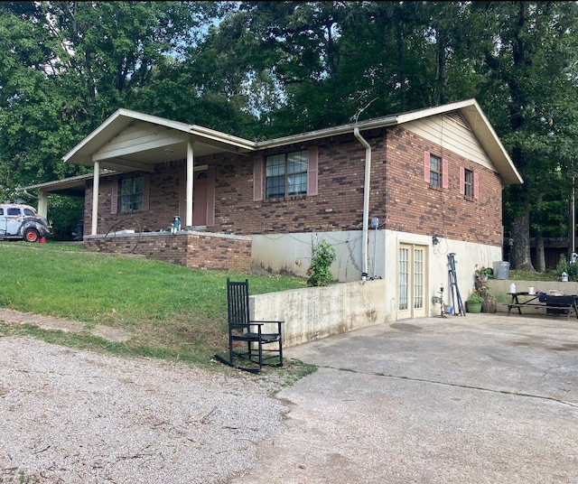 view of front of house with a front yard and french doors