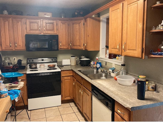 kitchen featuring sink, white appliances, and light tile flooring