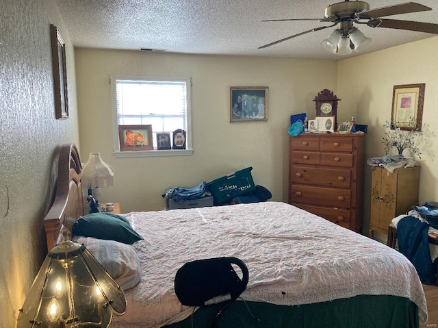 bedroom featuring ceiling fan and a textured ceiling