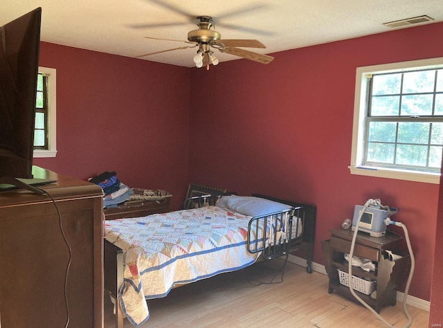 bedroom featuring hardwood / wood-style flooring and ceiling fan