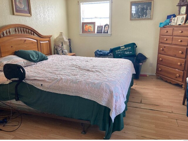 bedroom with hardwood / wood-style flooring