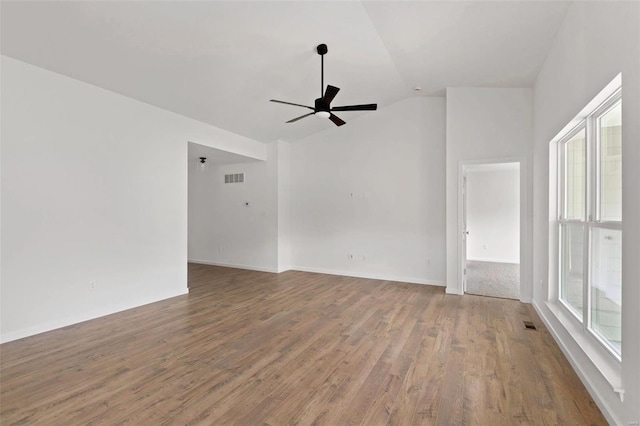 unfurnished room featuring ceiling fan, hardwood / wood-style floors, and vaulted ceiling