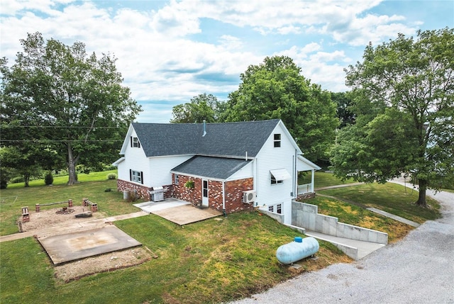 view of front of home with a patio area and a front yard