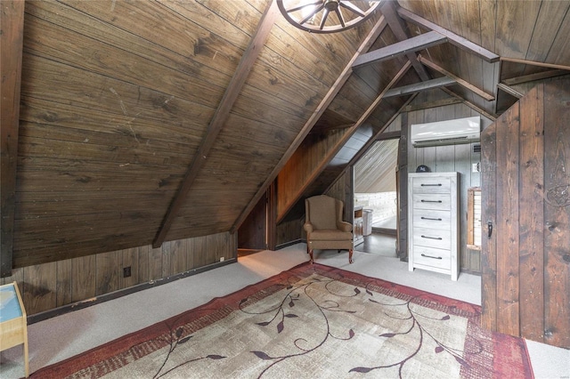 bonus room with lofted ceiling with beams, a wall mounted AC, and wood walls