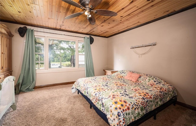 carpeted bedroom with wood ceiling, ceiling fan, and ornamental molding