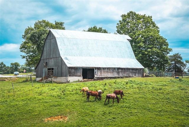 view of outdoor structure with a rural view and a yard