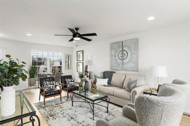 living room featuring ceiling fan and light hardwood / wood-style flooring