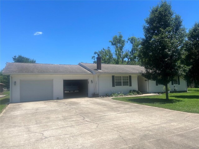 single story home with a garage and a front yard